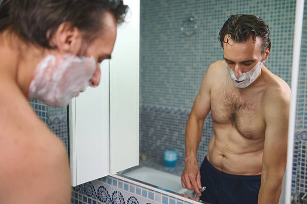 istock Man Shaving In Bathroom Mirror With Foam On Beard, Morning Routine 2243281158