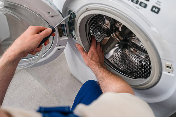 istock Home repair service fixing a washing machine in a modern laundry room 2243281340