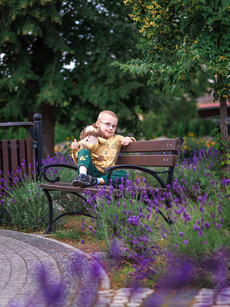 istock Child with toy lion on bench in lavender park 2243281393