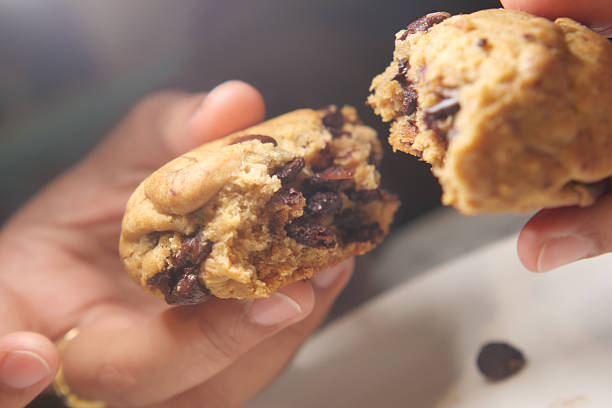 istock Delicious chocolate chip cookie being enjoyed by hand 2243282997