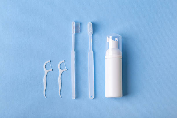 istock Toothbrushes, dental floss and toothpaste from above on blue background. 2243283217