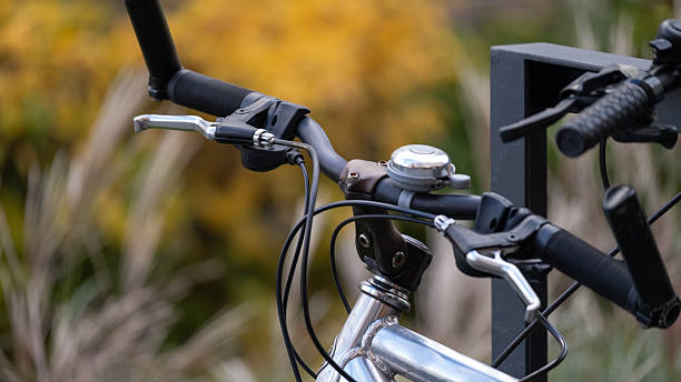 istock Bicycle handlebars and bell in urban outdoor setting 2243286641