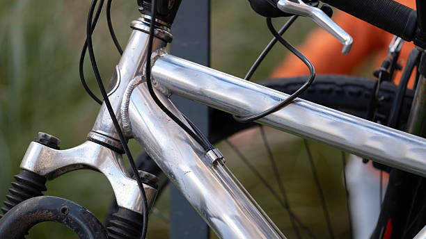 istock Close-up of silver bicycle frame and cables outdoors 2243287731