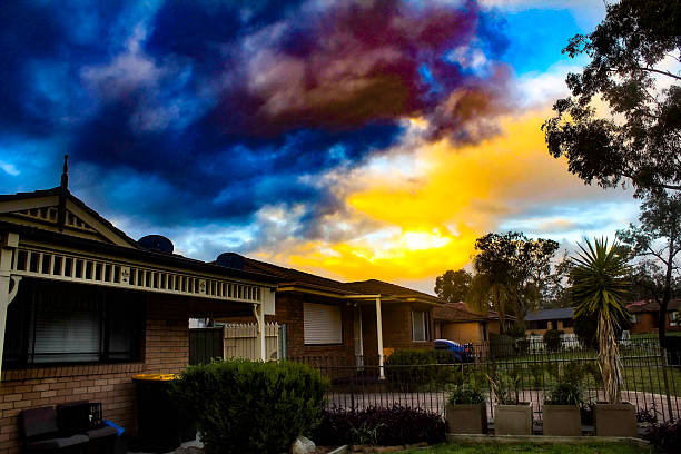 A dramatic sunset casts vibrant hues of orange, yellow, and deep blue across the sky above a suburban house in Sydney, NSW, Australia. (Photo by Tara Chand Malhotra)