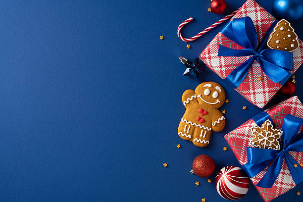 istock Festive scene featuring wrapped gifts, cookies, and ornaments arranged on a blue backdrop, capturing the spirit of Christmas and New Year celebrations, gift giving, and seasonal greetings 2243294895