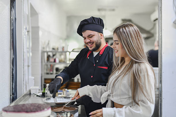 istock Friendly Chef And Staff Cooking Together In Bright Commercial Kitchen, Dessert Preparation Scene 2243296736