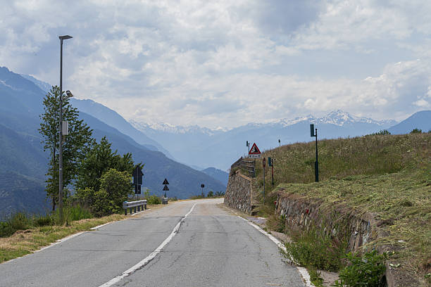 istock Curved mountain road with forest slope and guardrail in alpine landscape 2243297480