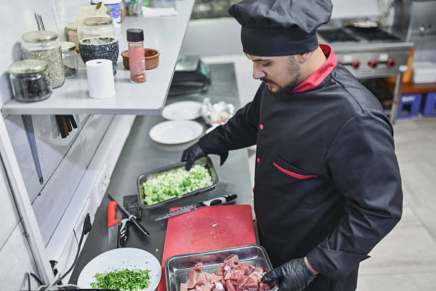 istock Professional Chef Preparing Fresh Ingredients in Modern Kitchen for Culinary Dishes 2243301093
