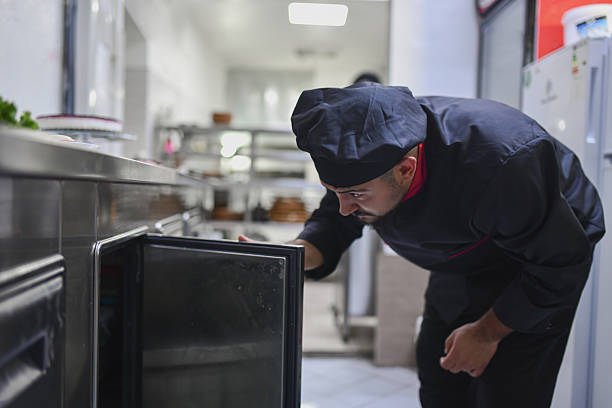 istock Professional Chef Checking the Kitchen Storage for Fresh Ingredients in Busy Commercial Kitchen 2243301810