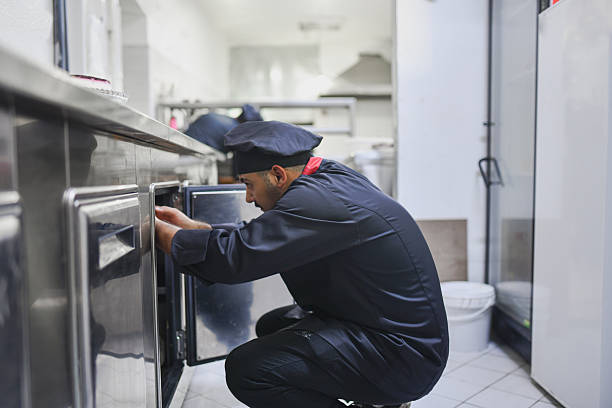 istock Chef Kneeling And Checking Storage In A Professional Kitchen For Efficient Food Preparation 2243302749