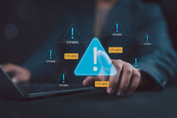 istock Cybersecurity threat and system warning alert concept. A Man typing a laptop with multiple digital warning signs, data breaches, malware attacks, and IT system vulnerability prevention. 2243302824
