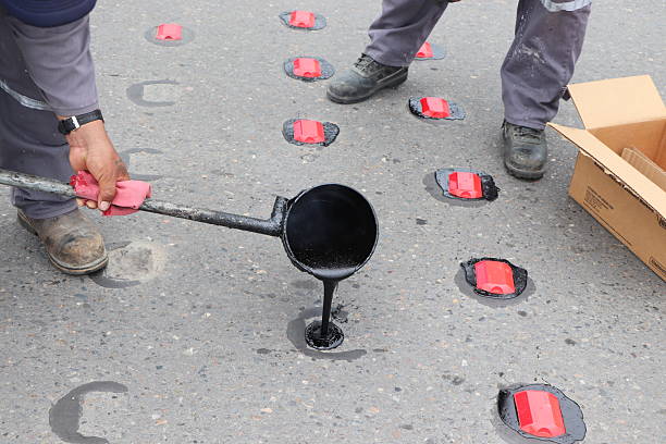 istock Road marking and maintenance work with paint, asphalt and reflective tacks 2243305082