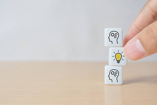 istock Concept creative idea and innovation. Hand picked dice with head human symbol and light bulb icon 2243309424