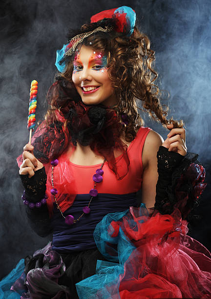 istock woman with creative make-up in doll style with candy. 2243310273
