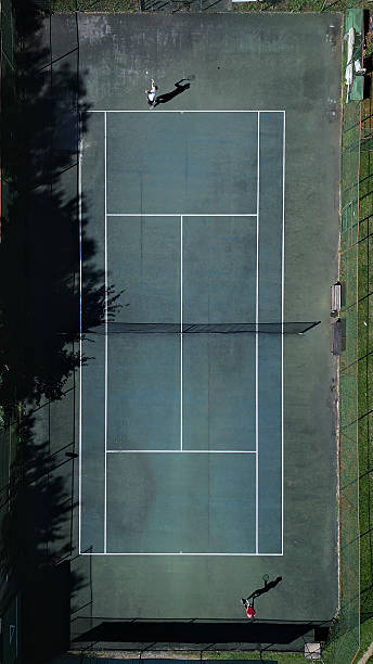 istock Aerial View Tennis Player Practicing on Hardcourt 2243310842