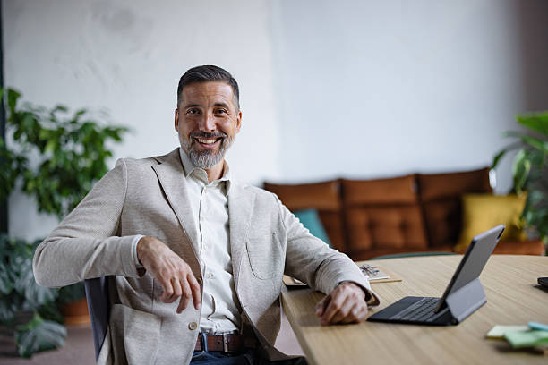 istock Professional businessman smiling at modern office desk 2243311106
