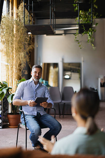 istock Employee having job interview with male recruiter using tablet 2243311151