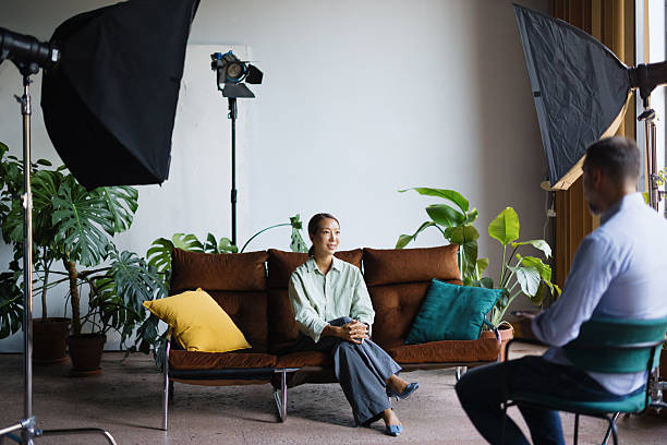istock Woman on sofa having professional studio photoshoot 2243311160