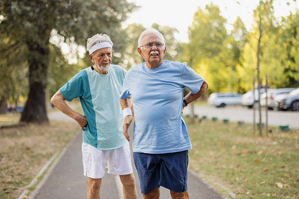 istock Senior men warming up for exercise in park 2243311281