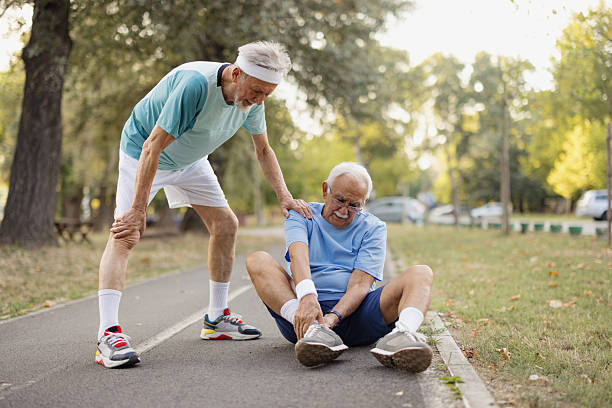 istock Senior man helping friend after twisting ankle during exercise 2243311293