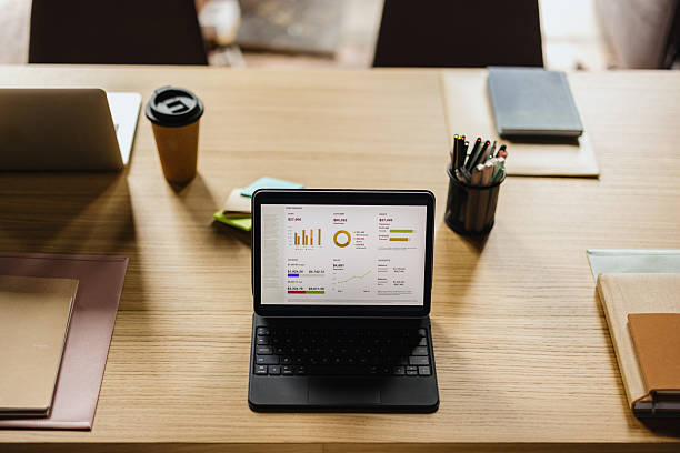 istock Business desk with tablet displaying financial data charts 2243311306