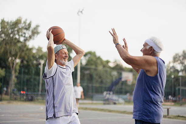 istock Senior men playing basketball outdoors, staying active 2243311507