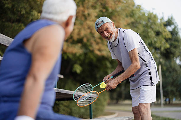 istock Senior men playing badminton, enjoying active retirement lifestyle 2243311556