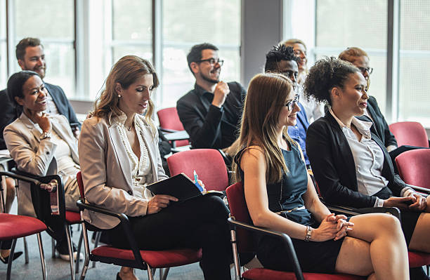 istock Diverse Business Executives Attentively Engaged in Conference Presentation 2243312597