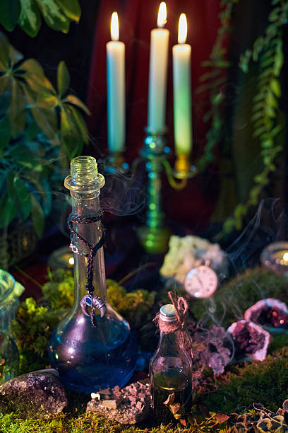 istock In a softly illuminated setting, a collection of potion bottles sits among lush plants. Candles flicker nearby, casting enchanting shadows as smoke wisps rise, creating a mystical vibe 2243317635