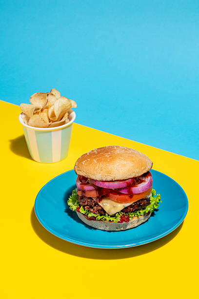 istock Pop of Color: Burger Against Yellow and Blue 2243317763