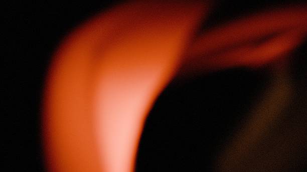 istock light red on dark background for cover header design, in a grainy noisy glowing 2243320750