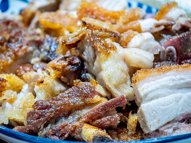 Close-up view of chopped Crispy Skin Chinese Roast Pork pieces on a serving plate