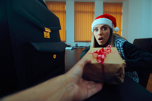 istock Surprised Woman Receiving a Christmas Gift from a Co-Worker 2243322260