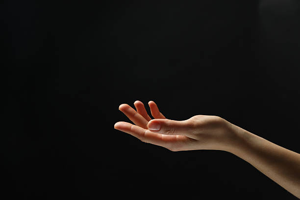 istock Woman holding something in hand on black background, closeup. Space for text 2243328733