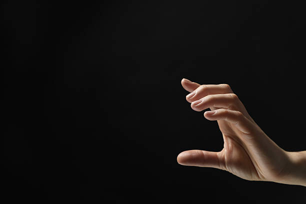istock Woman holding something in hand on black background, closeup. Space for text 2243328767