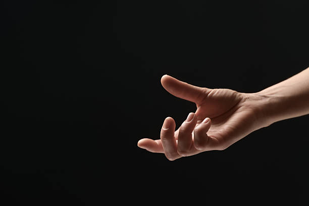 istock Woman holding something in hand on black background, closeup. Space for text 2243328770