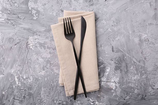 istock Elegant cutlery and kitchen towel on grey textured table, top view 2243329880