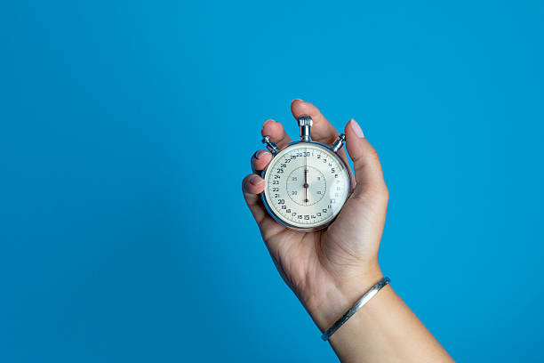 istock Vintage Stopwatch in Hand on Blue Background 2243330035