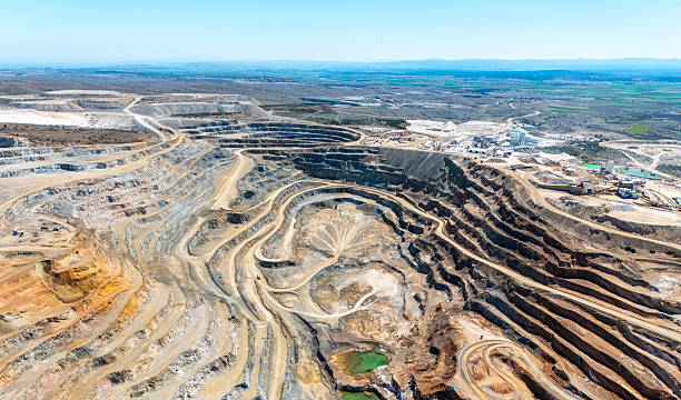 istock Aerial View of Open-Pit Mining Quarry with Terraced Excavation Layers 2243331138