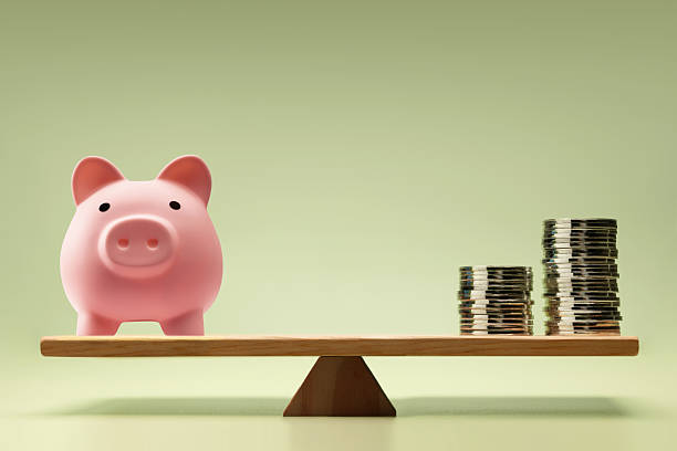 istock Financial concept with Coin money Stack and Piggybank balanced on a scale 2243336731
