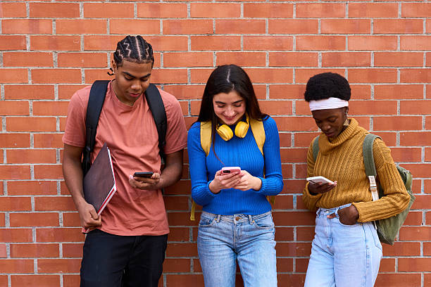 istock Diverse students connecting with smartphones on campus 2243337729
