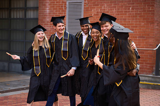 istock Happy graduates celebrating university achievement holding diplomas 2243337854