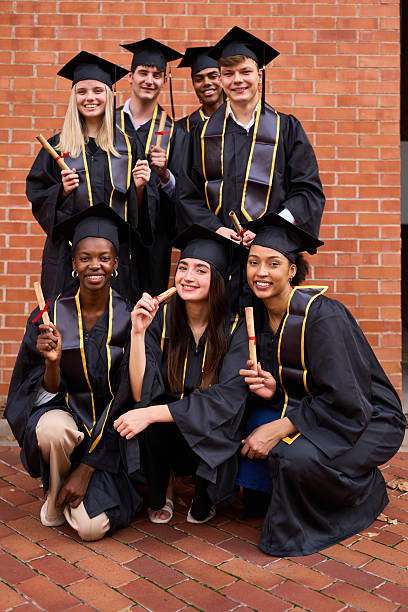 istock Diverse students celebrating graduation, holding diplomas 2243337856