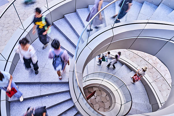 istock Modern Architecture Spiral Staircase with People 2243338039