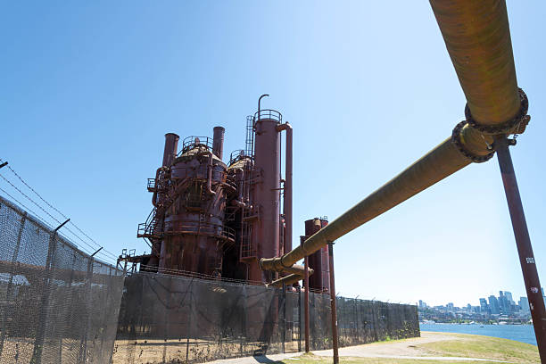 istock Low angle view of massive metal structures remaining from an oil plant 2243339668