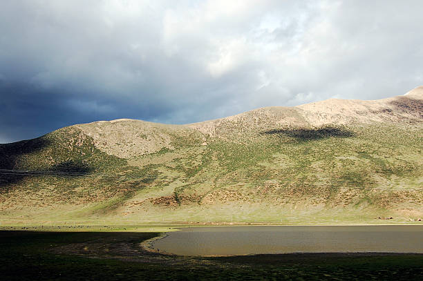 istock Mountainous landscape with a lake under a cloudy sky 2243343368