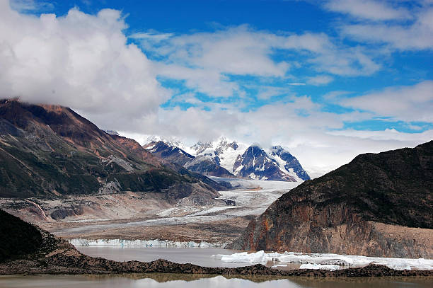 istock Breathtaking Glacial Landscape with Snow-Capped Peaks and Clouds 2243343398
