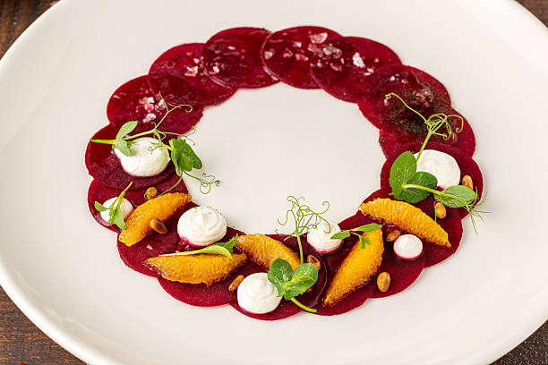 istock Beet carpaccio with orange slices, fresh greens and cream dots 2243345684