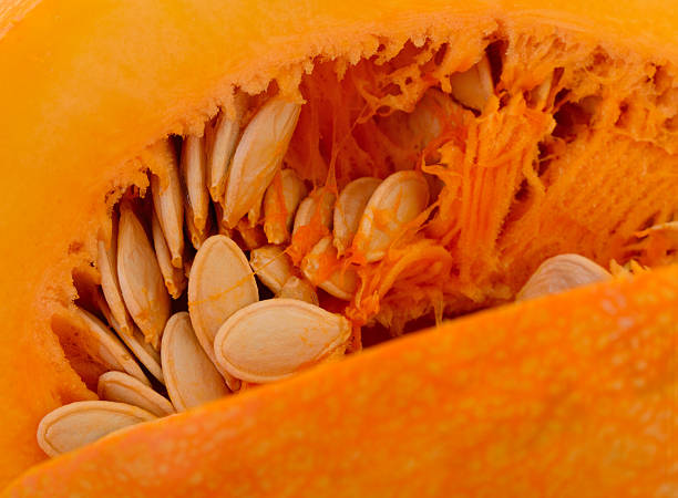 istock Pumpkin seeds inside fresh pumpkin macro close up 2243346724
