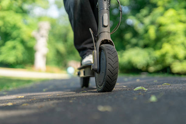 istock Rider enjoying a smooth ride on a scooter along a quiet park path surrounded by greenery 2243351142